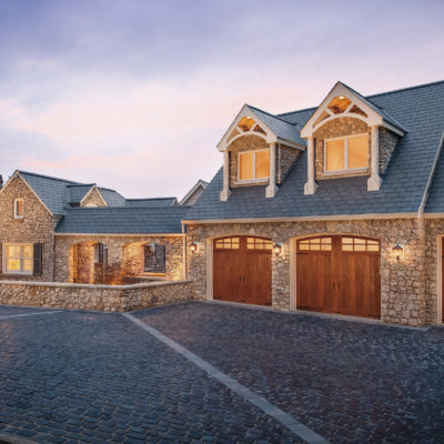 arched garage door with windows in faux wood by clopay