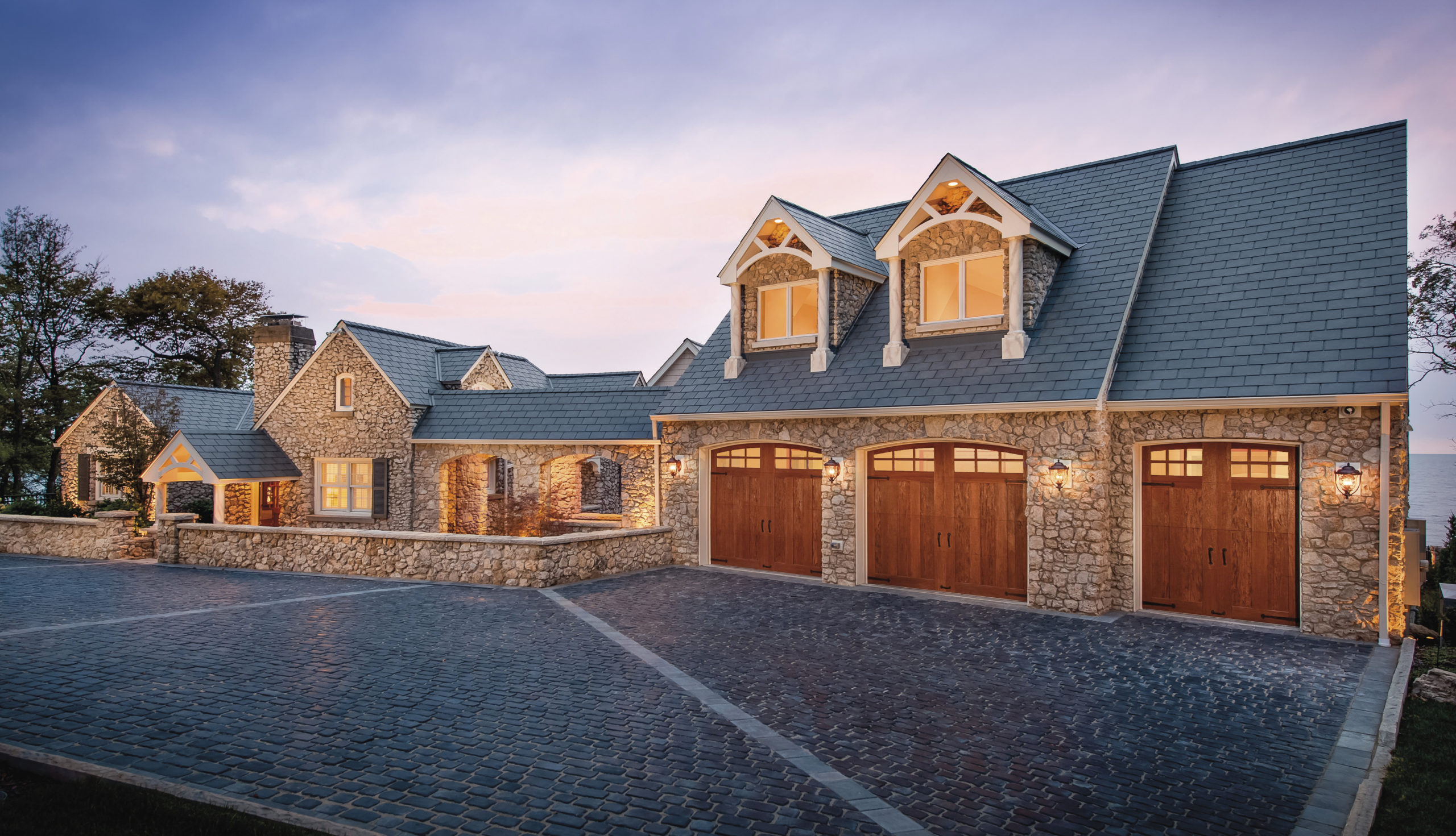 arched garage door with windows in faux wood by clopay