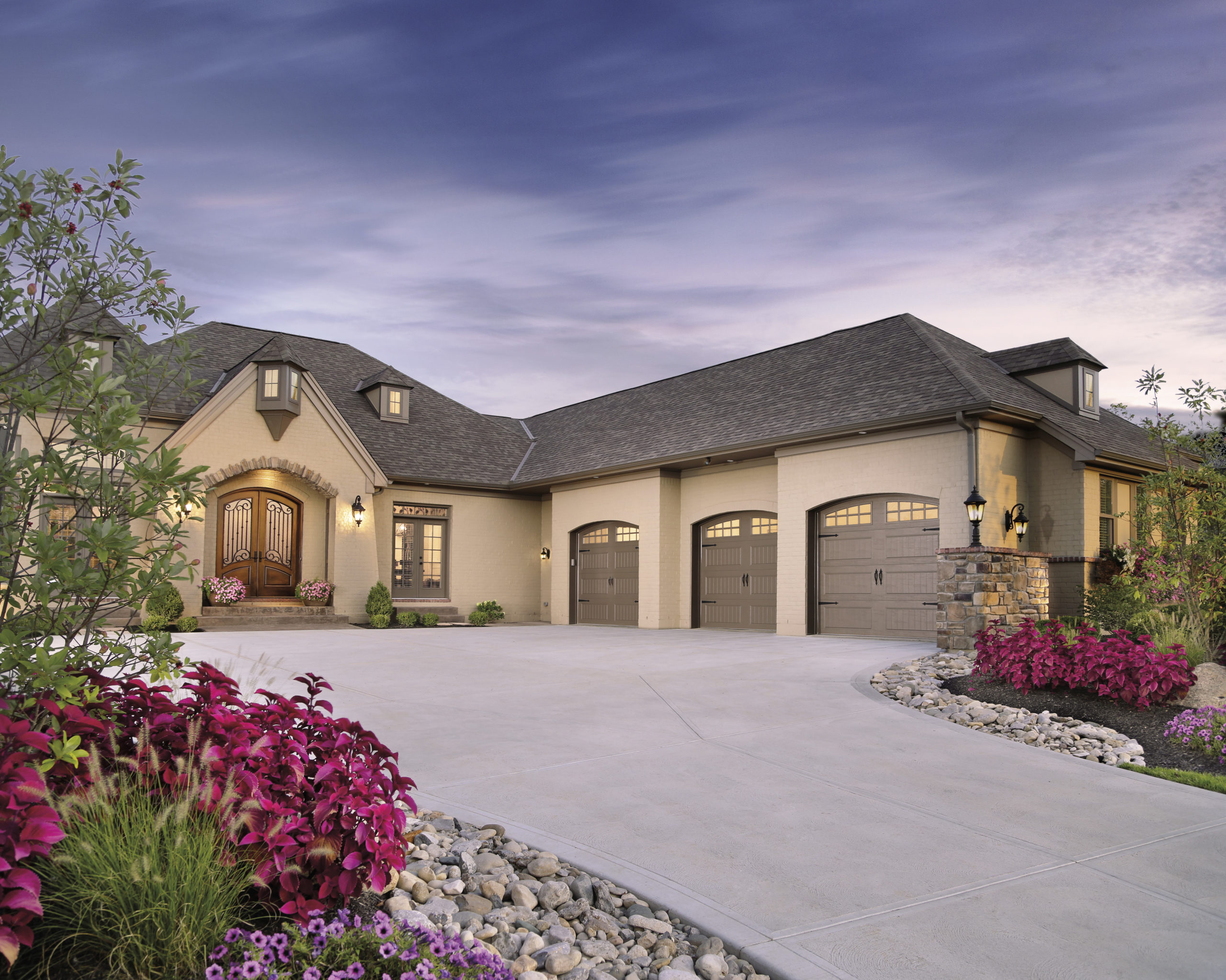 arched brown garage doors in steel by clopay