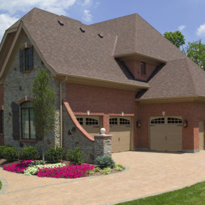 tan steel garage doors with arched windows by clopay