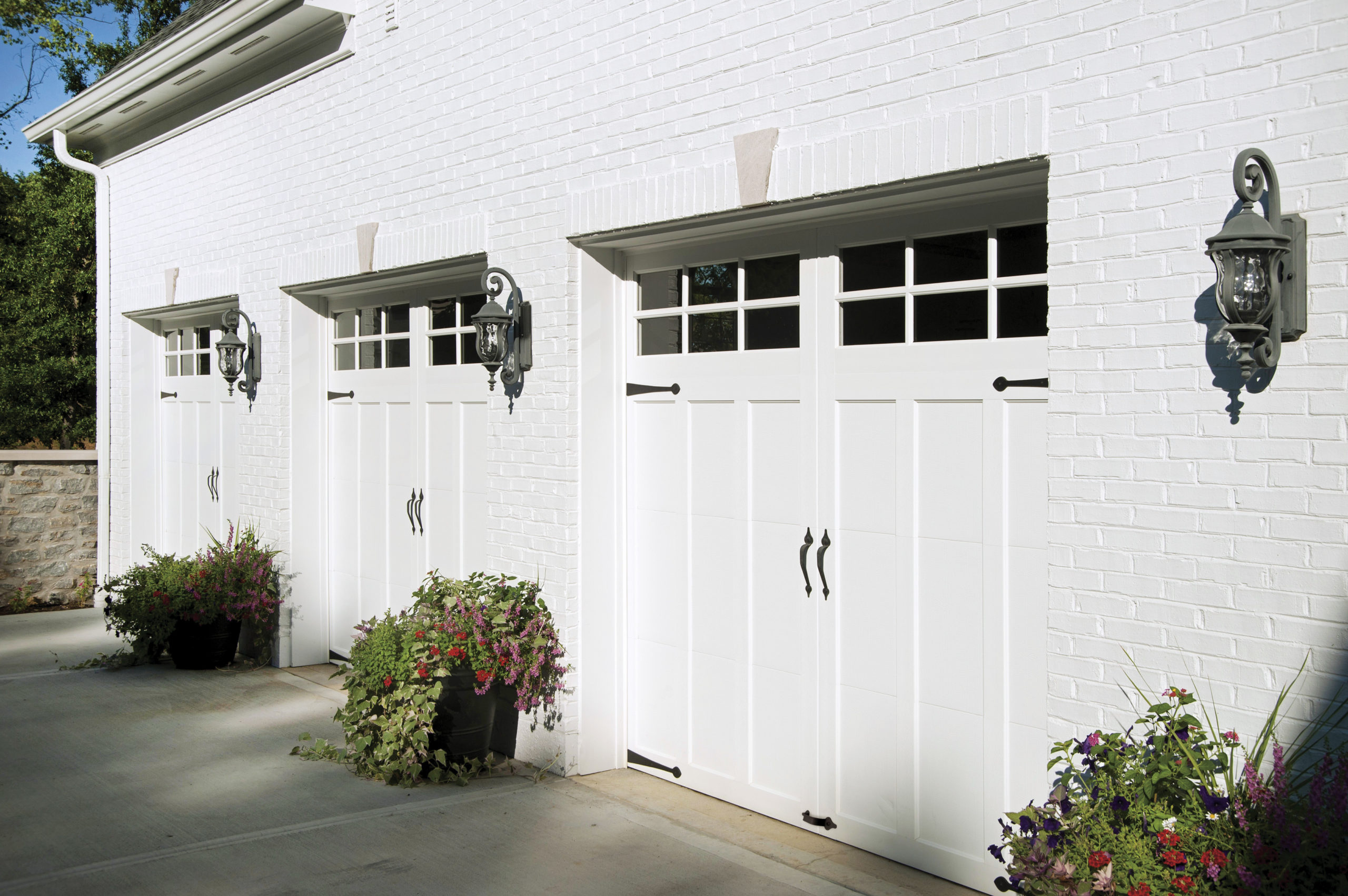 three single car garage doors in white with windows