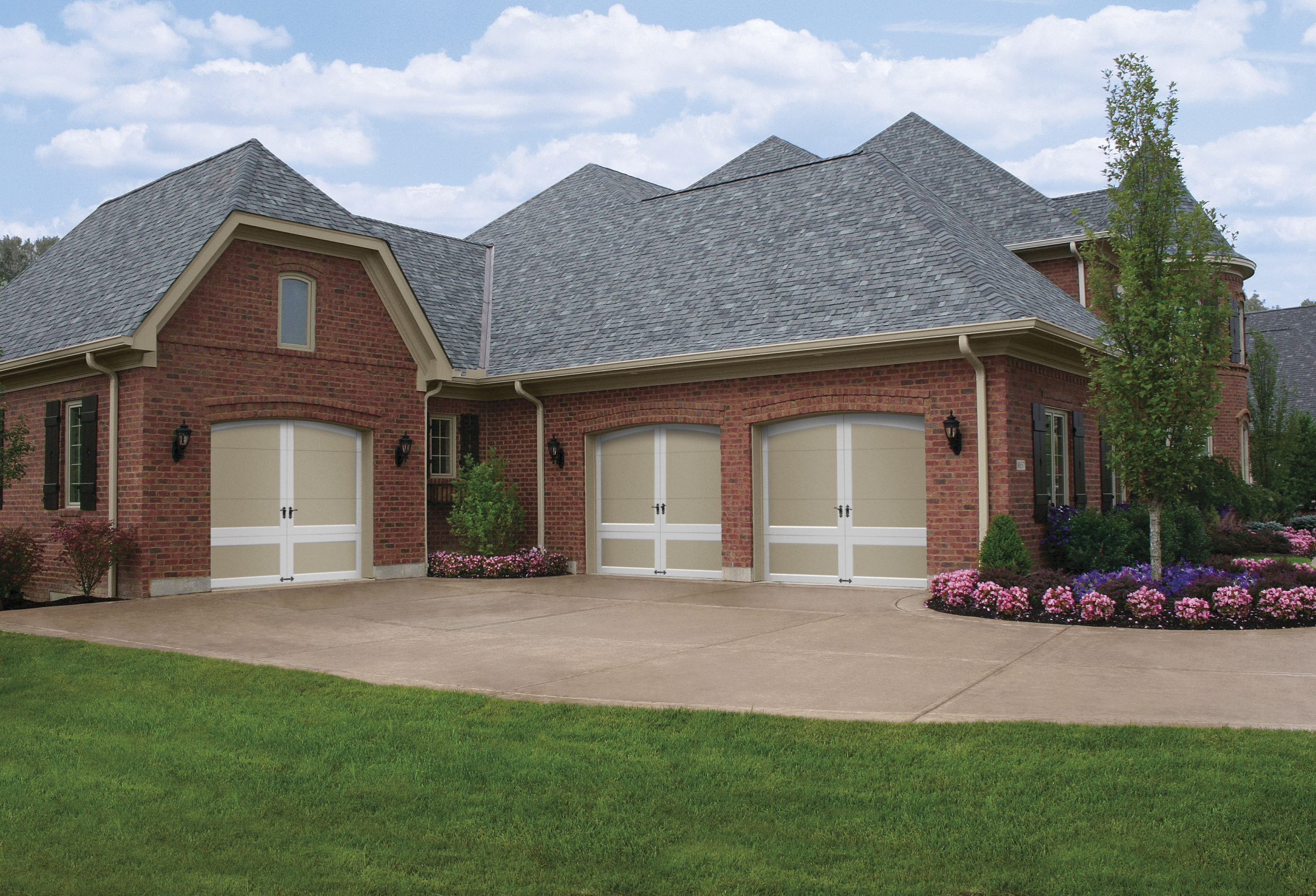 white and tan arched garage doors by clopay