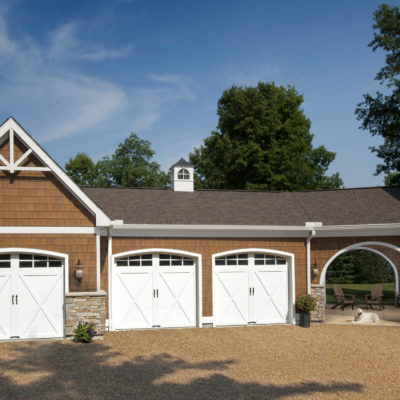 white arched garage door with xs and windows by clopay