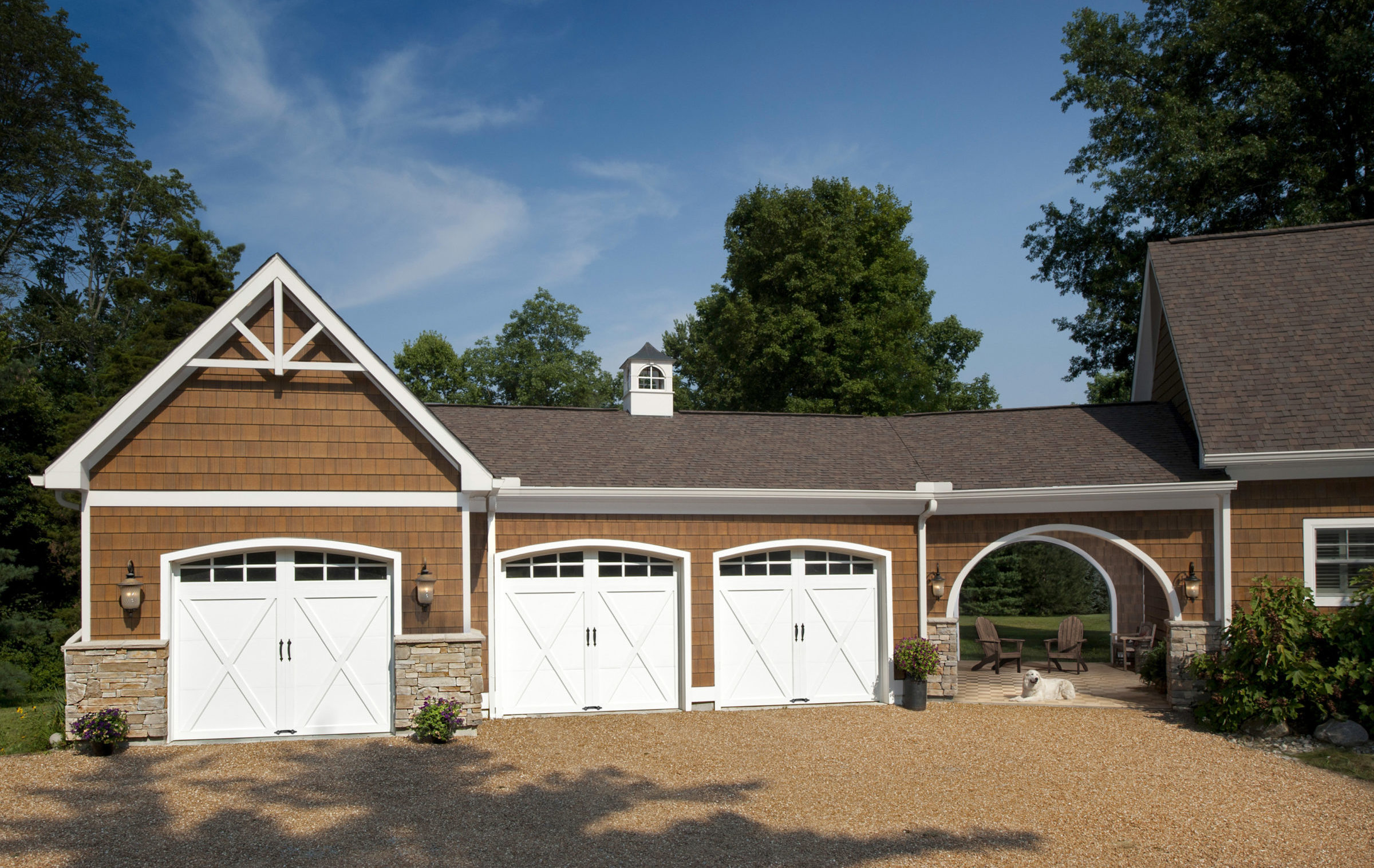 white arched garage door with xs and windows by clopay