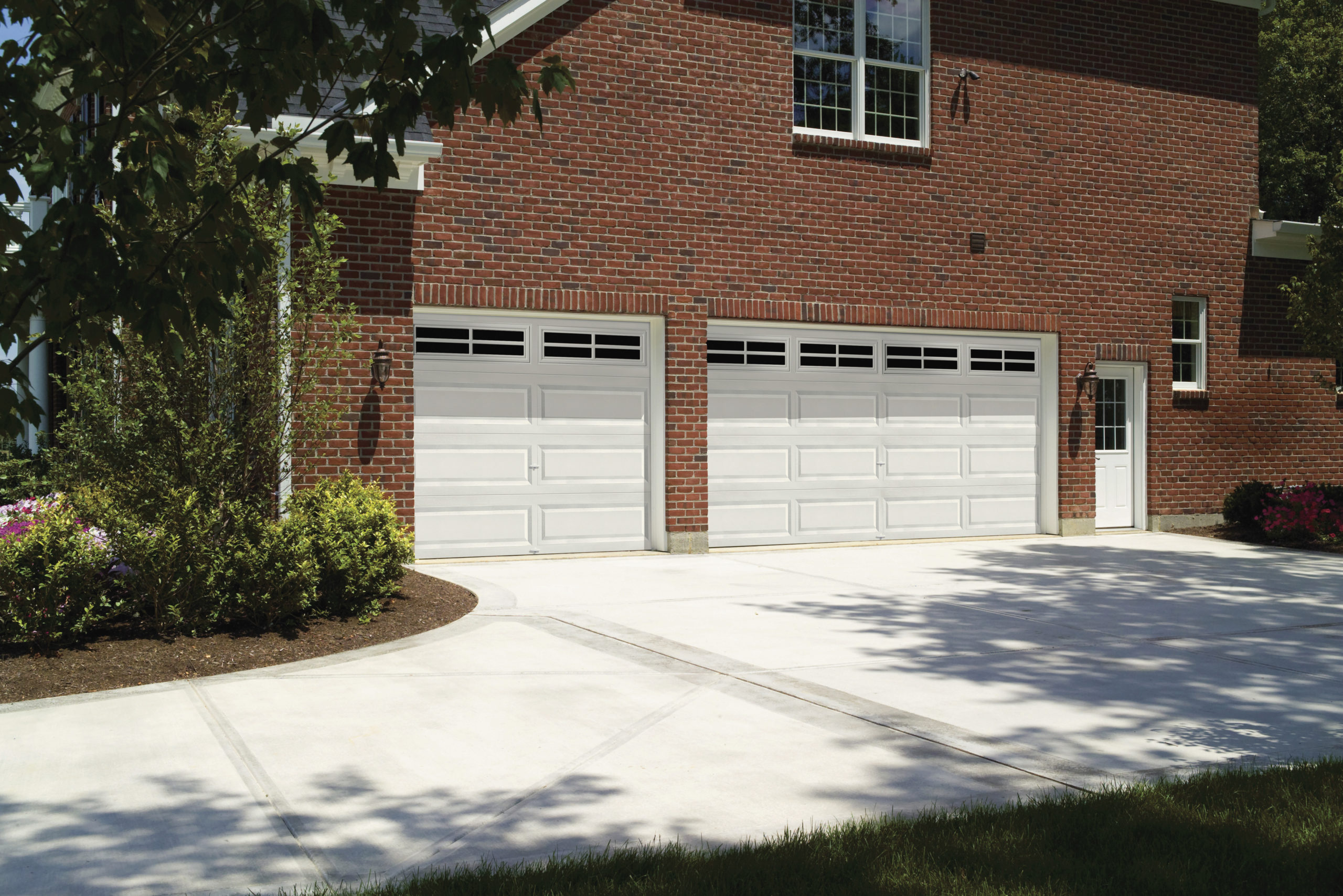 white garage door with oversized panels and rectangular windows by clopay