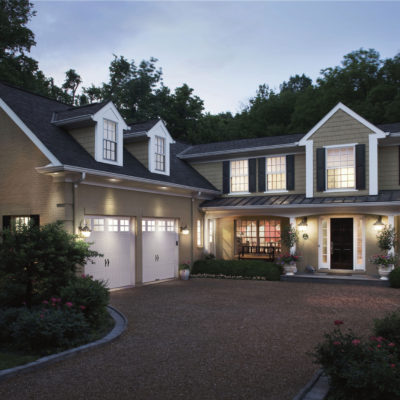 white steel garage doors wih hardware and rectangular windows by clopay