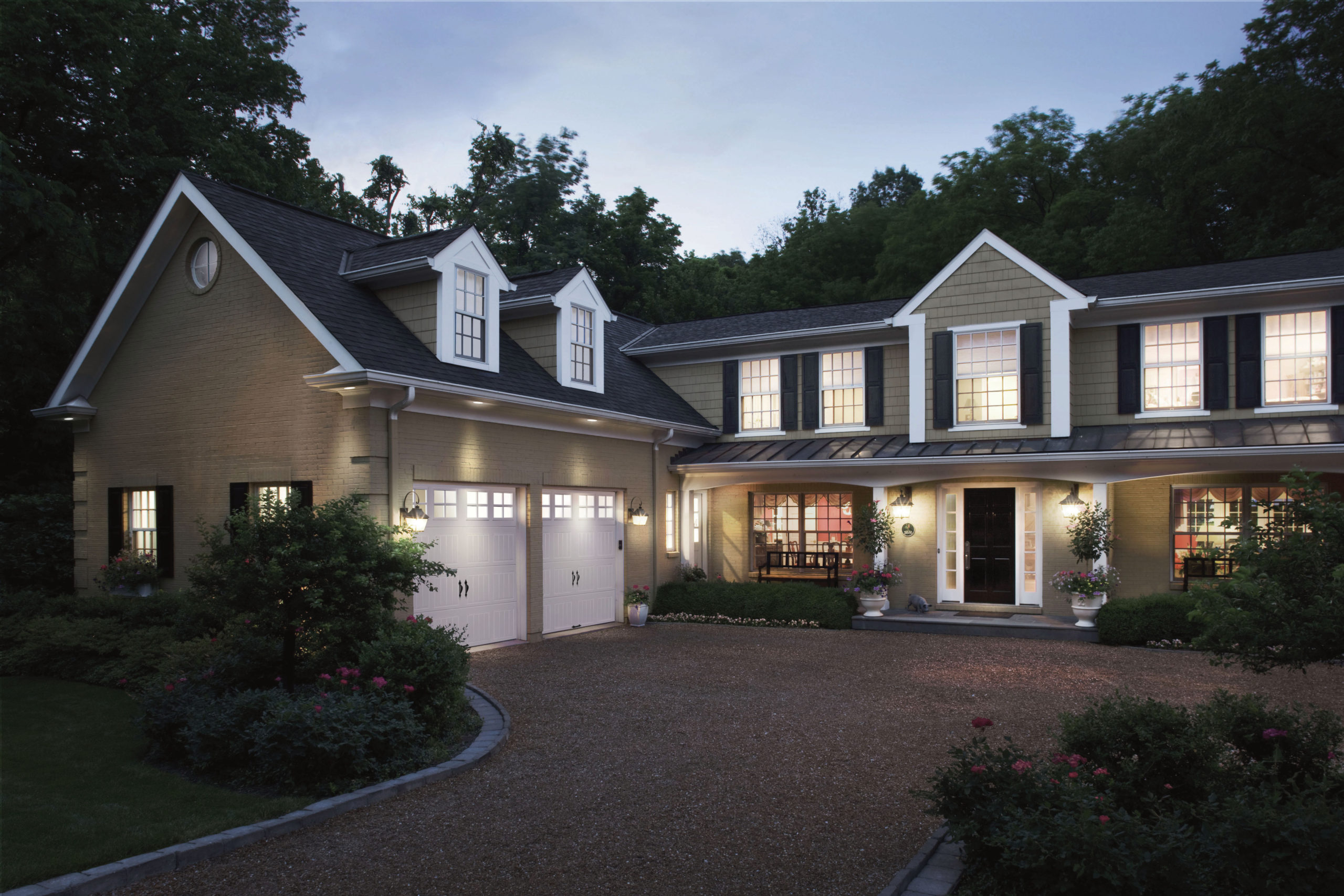 white steel garage doors wih hardware and rectangular windows by clopay