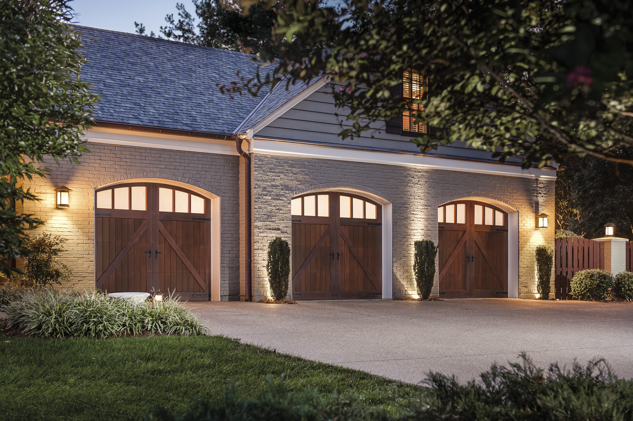 arched single car wood garage doors with windows by clopay