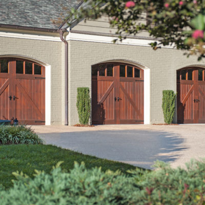 arched wood garage doors with windows by clopay