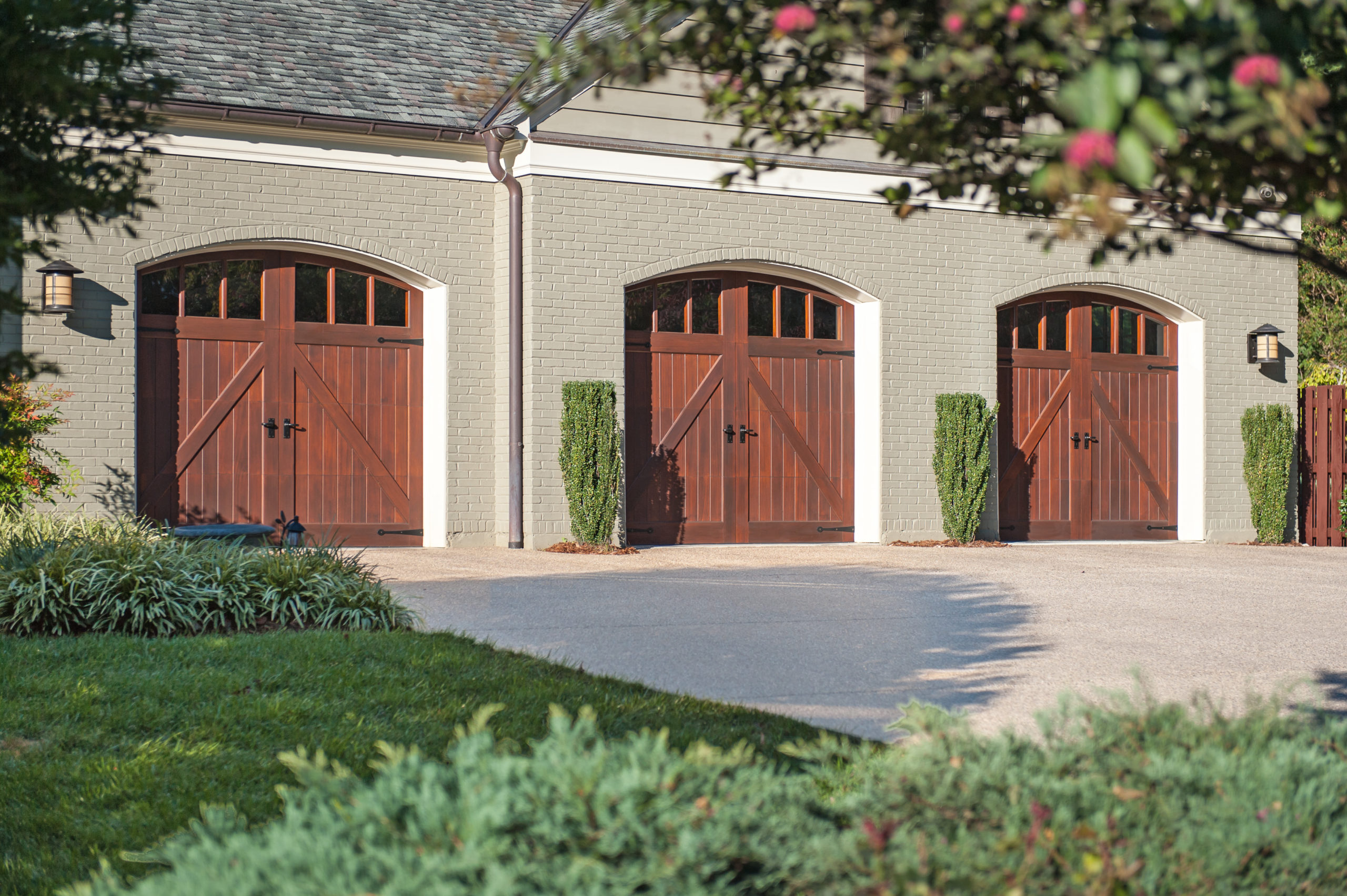 arched wood garage doors with windows by clopay