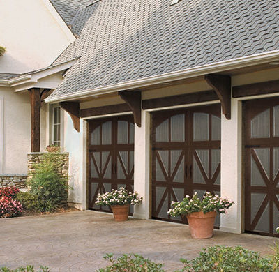 tudor style garage door in wood with arched windows by amarr