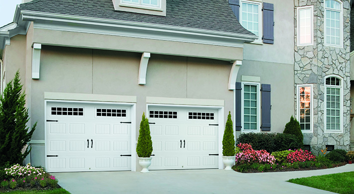 white steel carriage style garage doors by amarr