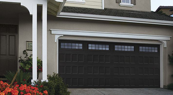 black two car steel garage door with windows and grids by amarr