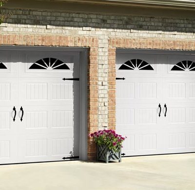 two white one car carriage house garage doors by amarr