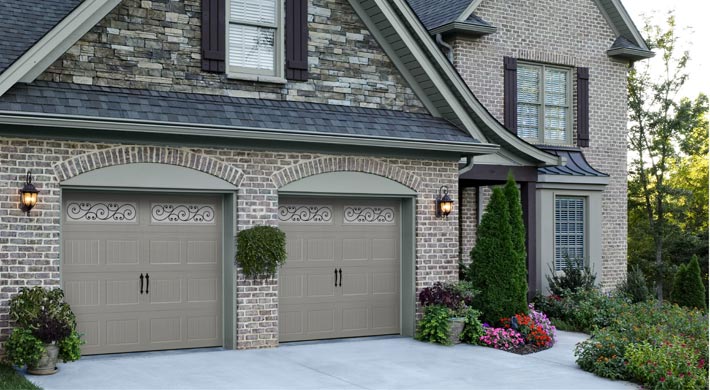 dark taupe single car garage door with iron in the windows