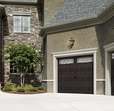 dark garage door with wrought iron windows by amarr