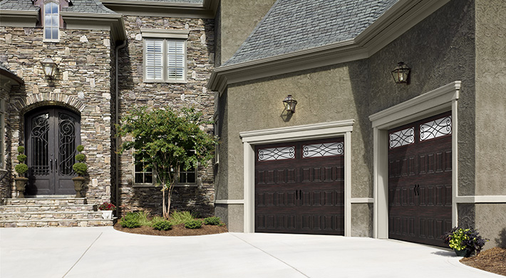 dark garage door with wrought iron windows by amarr