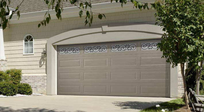 taupe garage door with wrought iron windows by amarr
