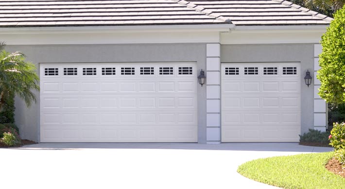 two car and one car garage door in steel white with windows by amarr
