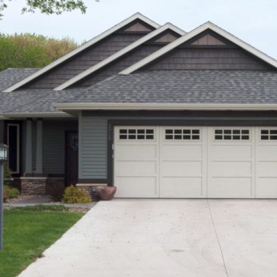 single story suburban house with wide overhead doors courtyard collection garage door.