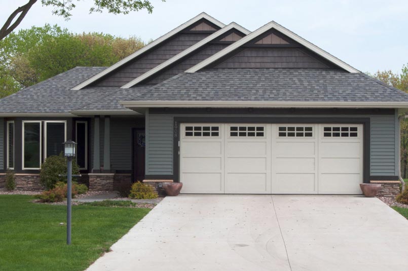 single story suburban house with wide overhead doors courtyard collection garage door.