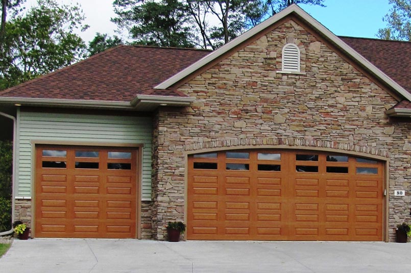 overhead doors impression fiberglass doors with a woodgrain finish and several windows