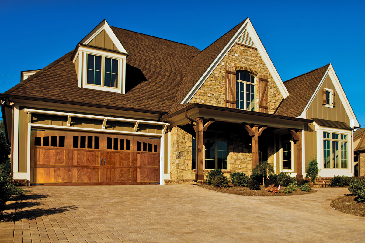 wide overhead signature carriage garage door with windows in top panel