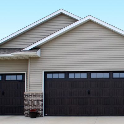 overhead thermacore garage doors in dark finish with several windows.