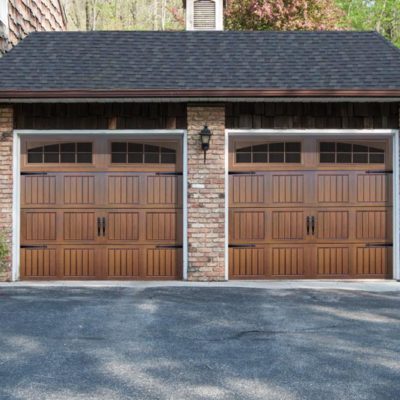 beautiful stained overhead thermacore wind load garage doors with decorative hardware and windows