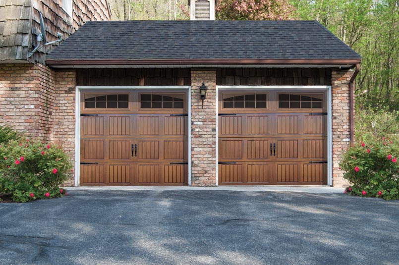 beautiful stained overhead thermacore wind load garage doors with decorative hardware and windows