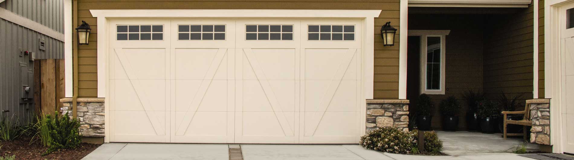 cream carriage house garage door with windows