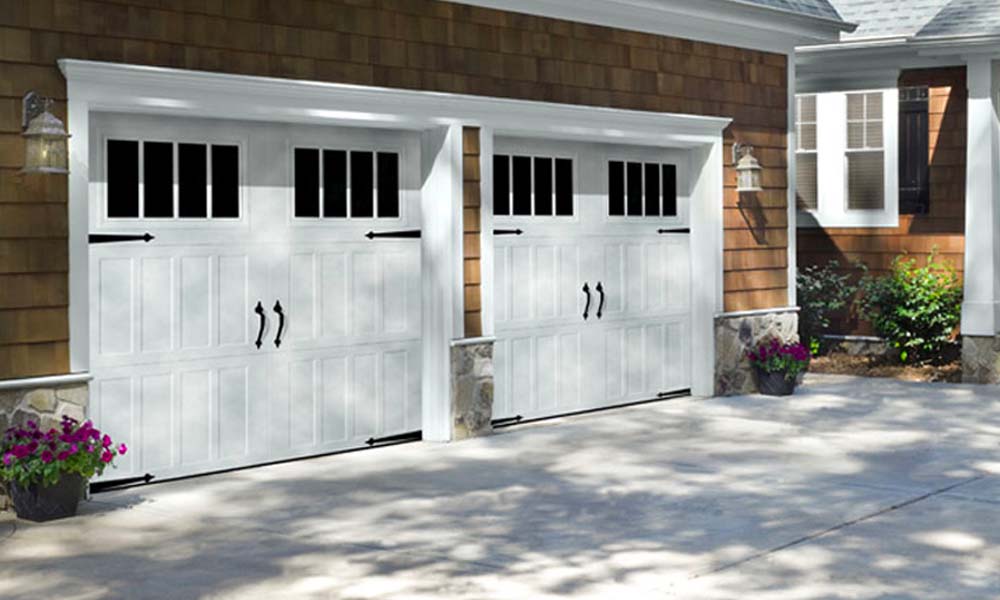 Amarr garage doors with windows and black hardware.