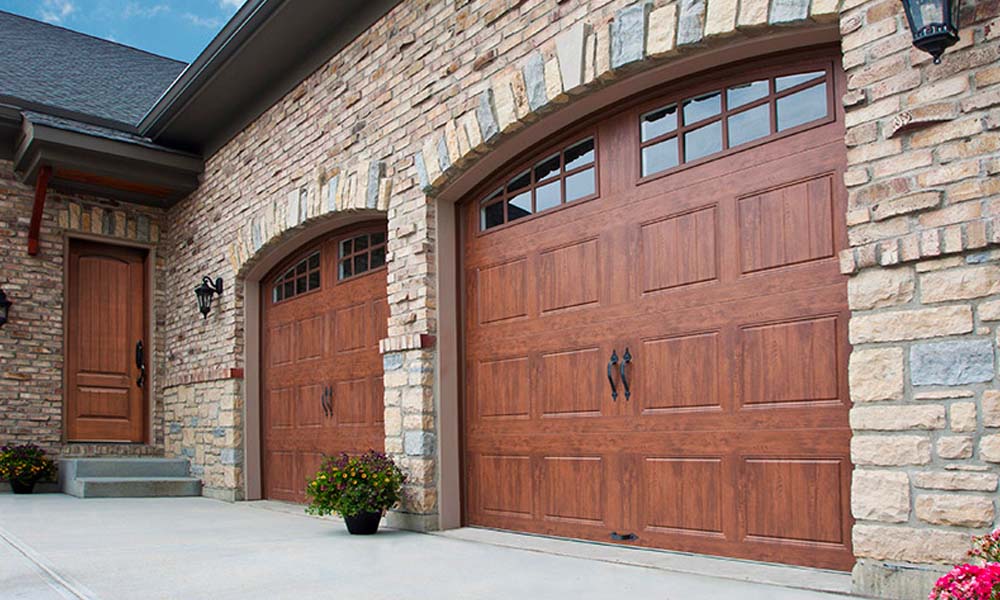 Beautiful traditional garage doors with arched top and windows from Clopay.