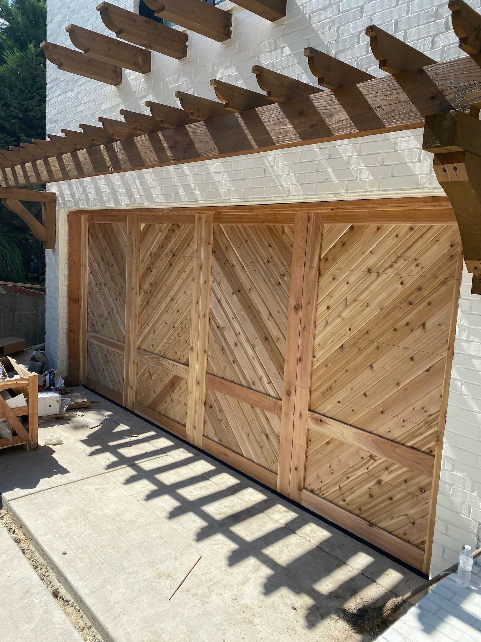 16x8 wood chevron garage door with white brick