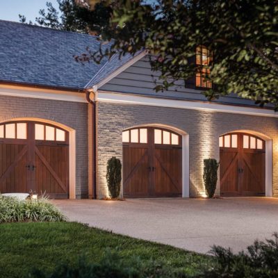 three 8x7 wood eyebrow garage doors with windows