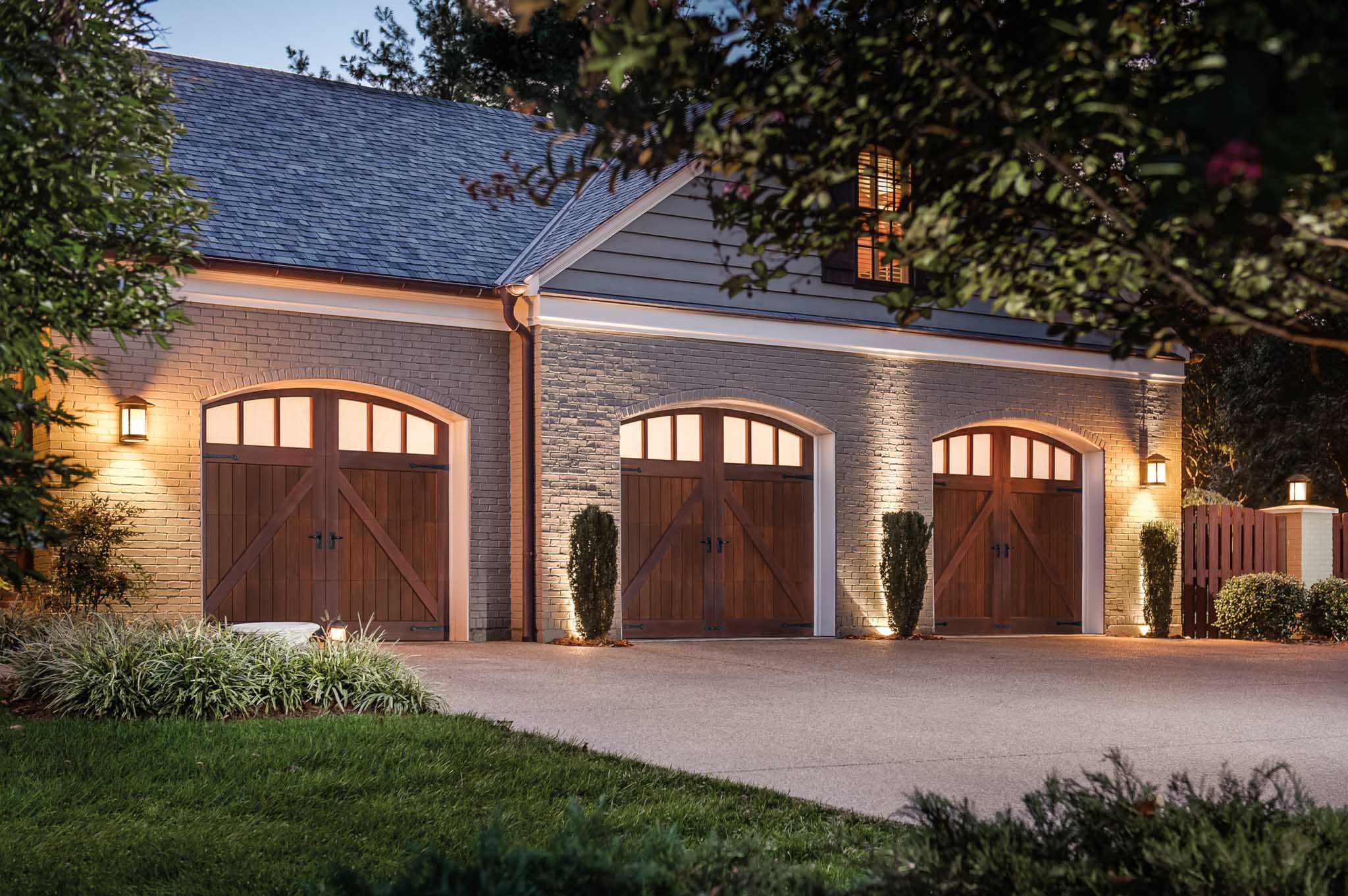 three 8x7 wood eyebrow garage doors with windows