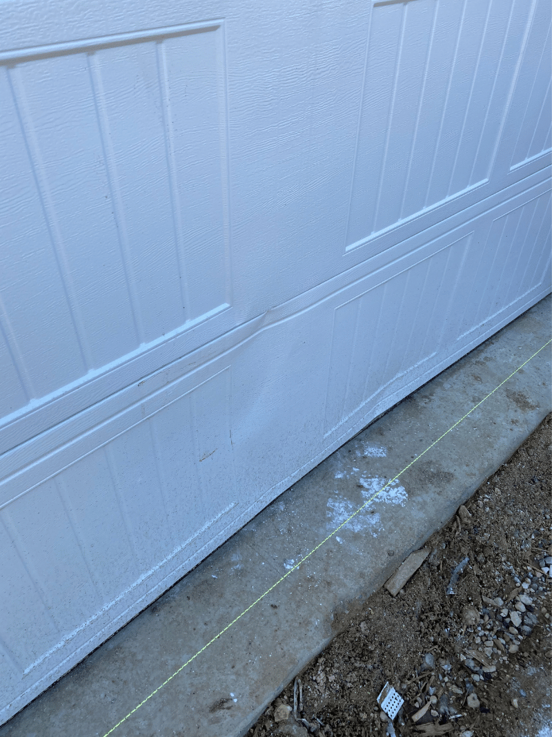 damaged dented bottom steel door section