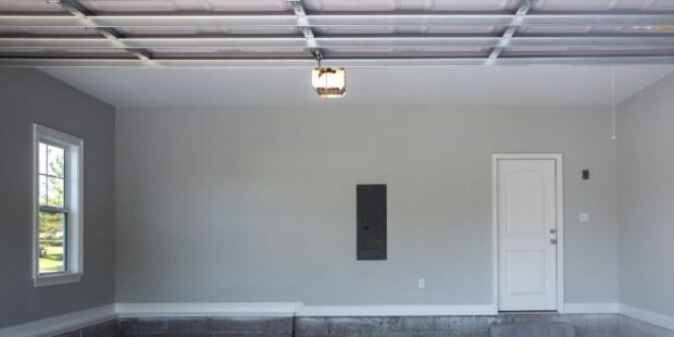 Interior view of open garage and opener with light on in the top center.