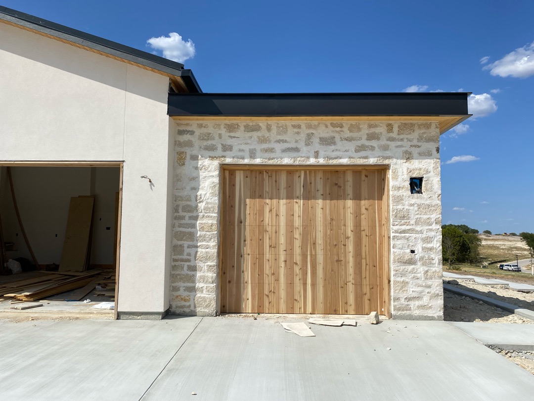 9x8 cedar vertical design garage door, white stucco and stone home