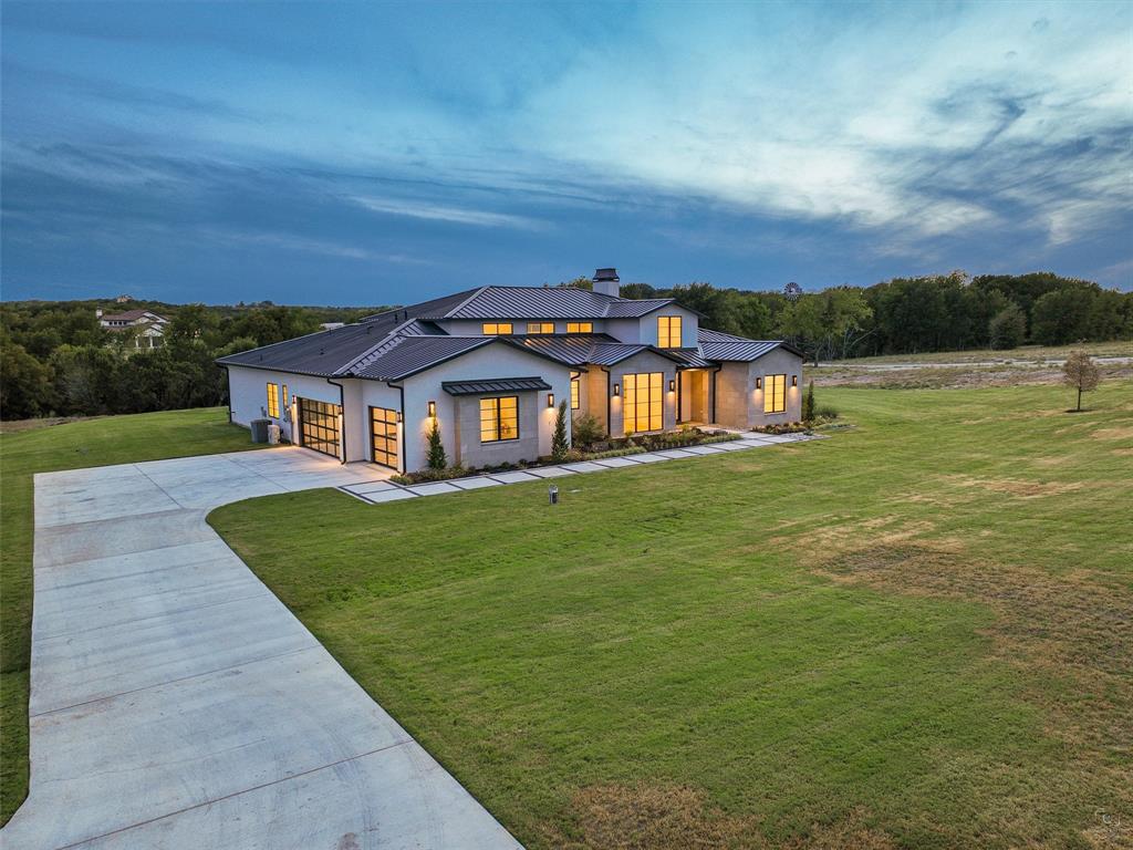 black glass garage doors, texas stone style home