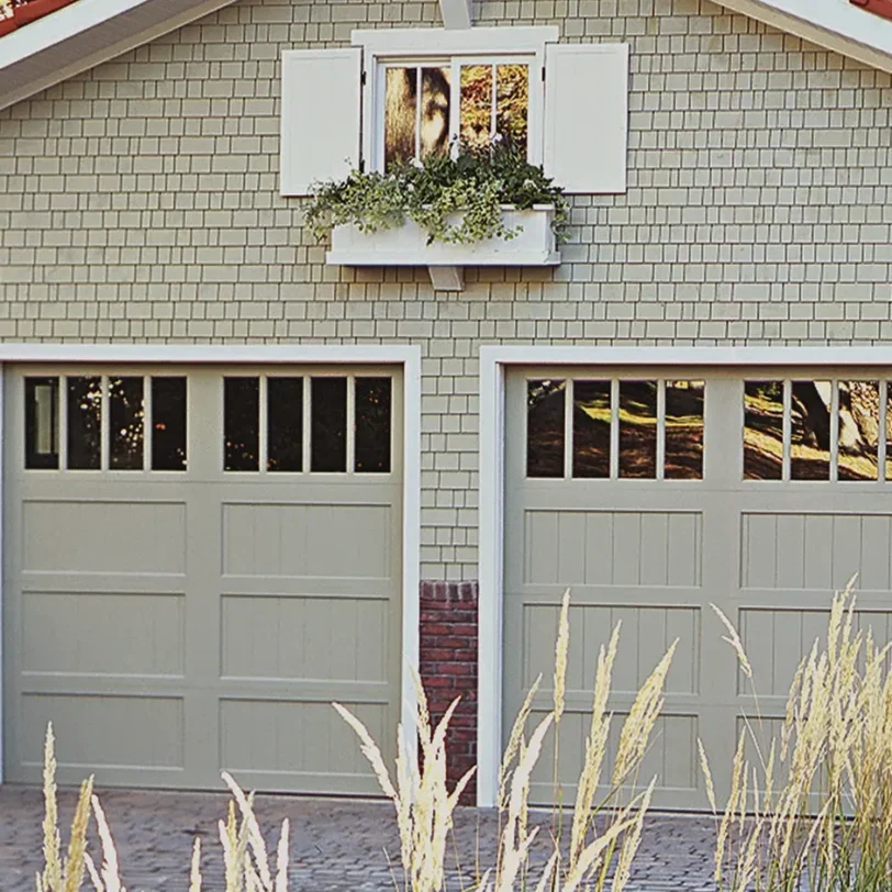 painted clopay reserve wood semi-custom garage door with a glass top section